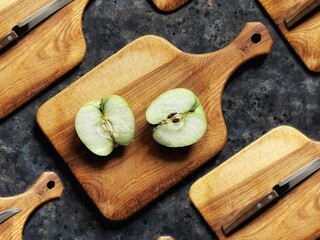 Pattern of slice of green apple and knife on wooden cutting board on black concrete background. Granny smith. Spring fruits background.
