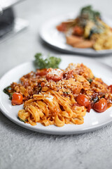 Pasta, spaghetti with tomato sauce on a light background