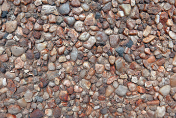 surface with small rounded brown stones with cement, ideal as a texture for a background