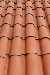 roof surface with reddish ceramic tiles embedded with each other