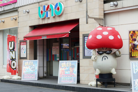 TOKYO, JAPAN - April 21, 2022: A Pachinko centre with an inflatable moving mushroom man outside in Tokyo's Minowa area.