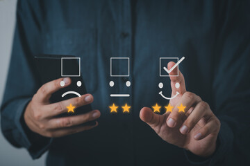Fototapeta premium Business people or customers show satisfaction through the application on the smart mobile phone screen. By giving the most or the best satisfaction rating.Customer service satisfaction survey concept