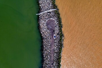 Top down done shot of a fishing area with multi coloured water