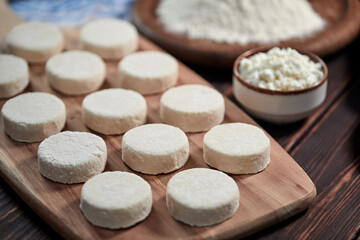 raw cottage cheese pancakes on the wooden board