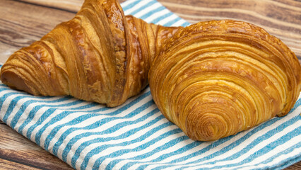 butter croissant isolated on a wooden background