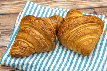 butter croissant isolated on a wooden background