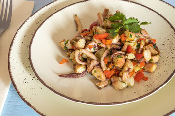 garlic squid salad in a plate on a table