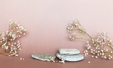 Empty pedestal made of natural stone for presentation of cosmetic products and delicate gypsophila flowers on light beige background. Advertising of spring rejuvenating cosmetics. Copy space, mockup
