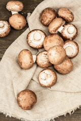 Fresh brown champignons in a wicker basket. Raw ingredients for cooking vegan food