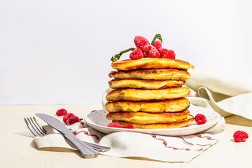Classic homemade American pancakes with frozen raspberries, hazelnut and mint. Healthy breakfast