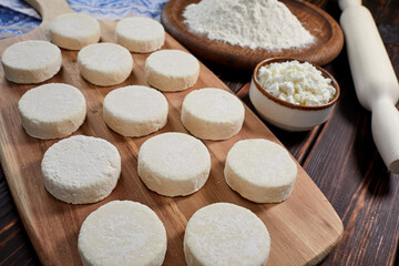 raw cottage cheese pancakes on the wooden board