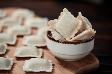 raw dumplings on teh wooden board