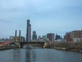 Fototapeta na wymiar Chicago skyline from Chicago River waterfront under slightly cloudy skies