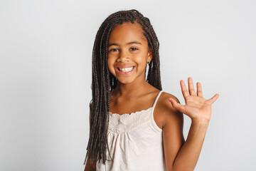Adorable african little girl on studio white background say hi © Louis-Paul Photo