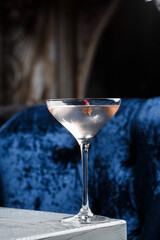 Summer refreshment drinks. Light pink rose cocktail, with rose wine on dark background. With rose flowers. Copy space