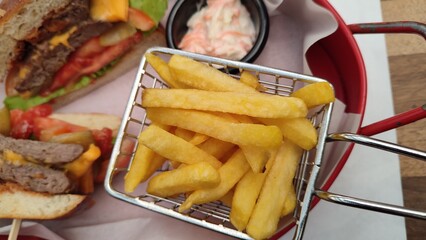 french fries potatoes next to hamburger 
