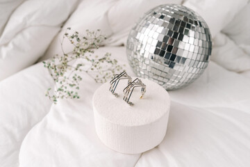 Silver modern bijouterie earrings on white background.