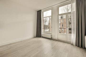 Spacious room in minimalist style, with large windows and access to the balcony