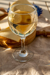 Spanish dry white wine and manchego cheese served on outdoor terrace in sunny day