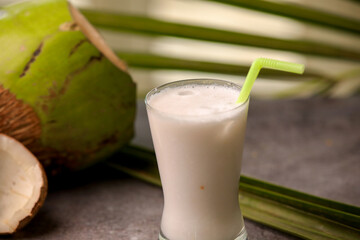 coconut juice or coconut milkshake summer coolant closeup with selective focus and blur