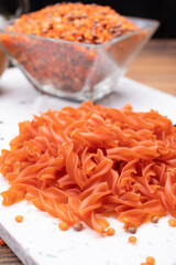 Vegan gluten free and vegetarian food, dried spiral pasta made from orange lentils legumes