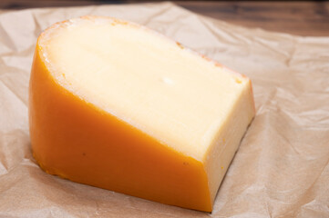 Piece of Dutch Gouda cheese ade from cow milk