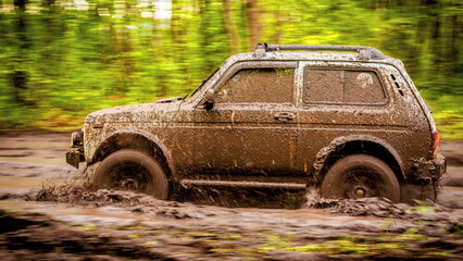 Dirty off-road car at a speed over dirt.