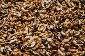 Background, texture of brown walnuts, peeled nuts. Food photography, top view.