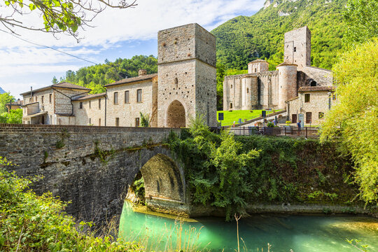 San Vittore alle Chiuse. Roman Catholic abbey and church. The edifice is known from the year 1011. Ponte Romano. Roman bridge over a small river. Italy.
