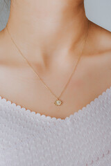 Close-up young woman wearing gold chain necklace. Modern fashion details. minimalist lifestyle
