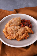 Breaded chicken cotoletta with tomato sauce