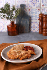 Breaded chicken cotoletta with tomato sauce