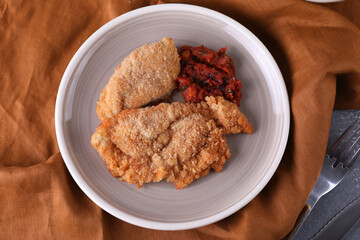 Breaded chicken cotoletta with tomato sauce