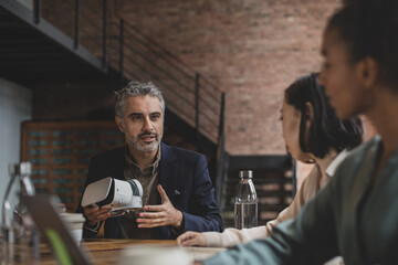 Middle Eastern male game designer leading a meeting