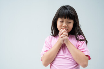 kid is praying, hands folded in prayer