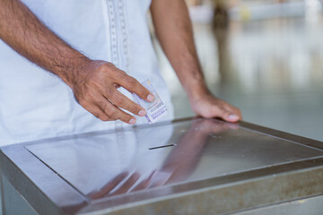 close up of hand put some money in to the charity box in the mosque