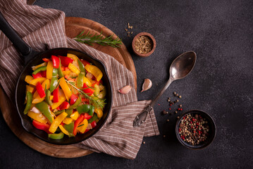 Cooked bell peppers of different colors, healthy vegetable dish