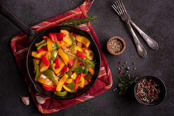Cooked bell peppers of different colors, healthy vegetable dish