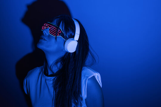 Woman in sunglasses listening to music