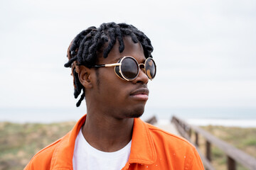 Black man walking on boardwalk