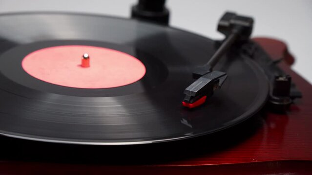Vinyl record player in action. Old school style cinemagraph loop vinyl record player. Close up view of vintage plate player. Old style sound technology to play music. Rotating vintage phonograph 