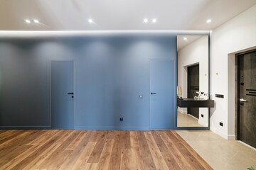Fototapeta na wymiar New, stylish, modern interior design of an apartment with a blue wall and wood floor