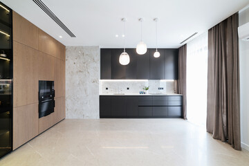Modern studio kitchen interior design with a large window and wardrobe