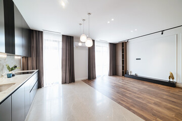 Fototapeta na wymiar Modern interior design of the apartment with large windows in the kitchen studio