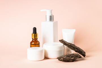 Natural cosmetic concept. Skincare product with tree bark at pastel background. Biophilic design.