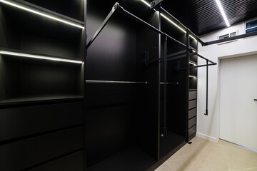 Modern wardrobe room for different clothes in black