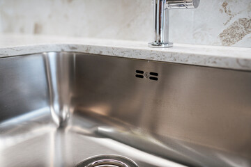 metal silver sink in the kitchen in a modern interior design