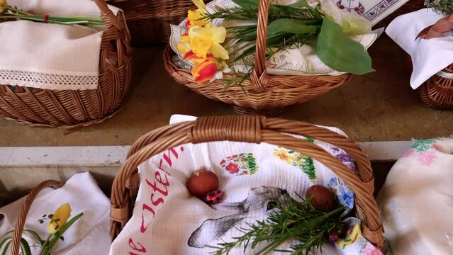 Olten, Switzerland - April 16, 2022: Baskets containing a sampling of Easter foods are brought to church to be blessed on Holy Saturday.