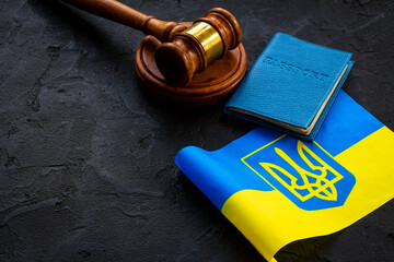 Ukrainian refugees concept. Flag with passport and gavel