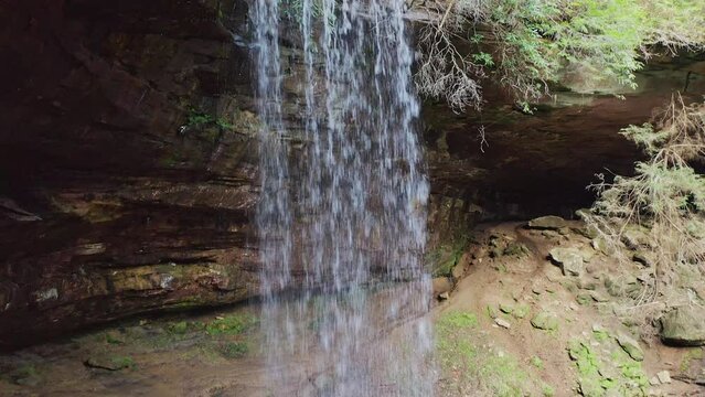 Drone Lowering Behind Waterfall Water